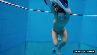 Sandy-haired honey swimming nude in the pool