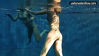 Two sumptuous amateurs showcasing their figures off under water