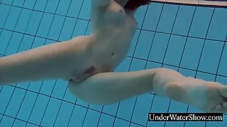 Wonderful red-haired in the white sundress underwater